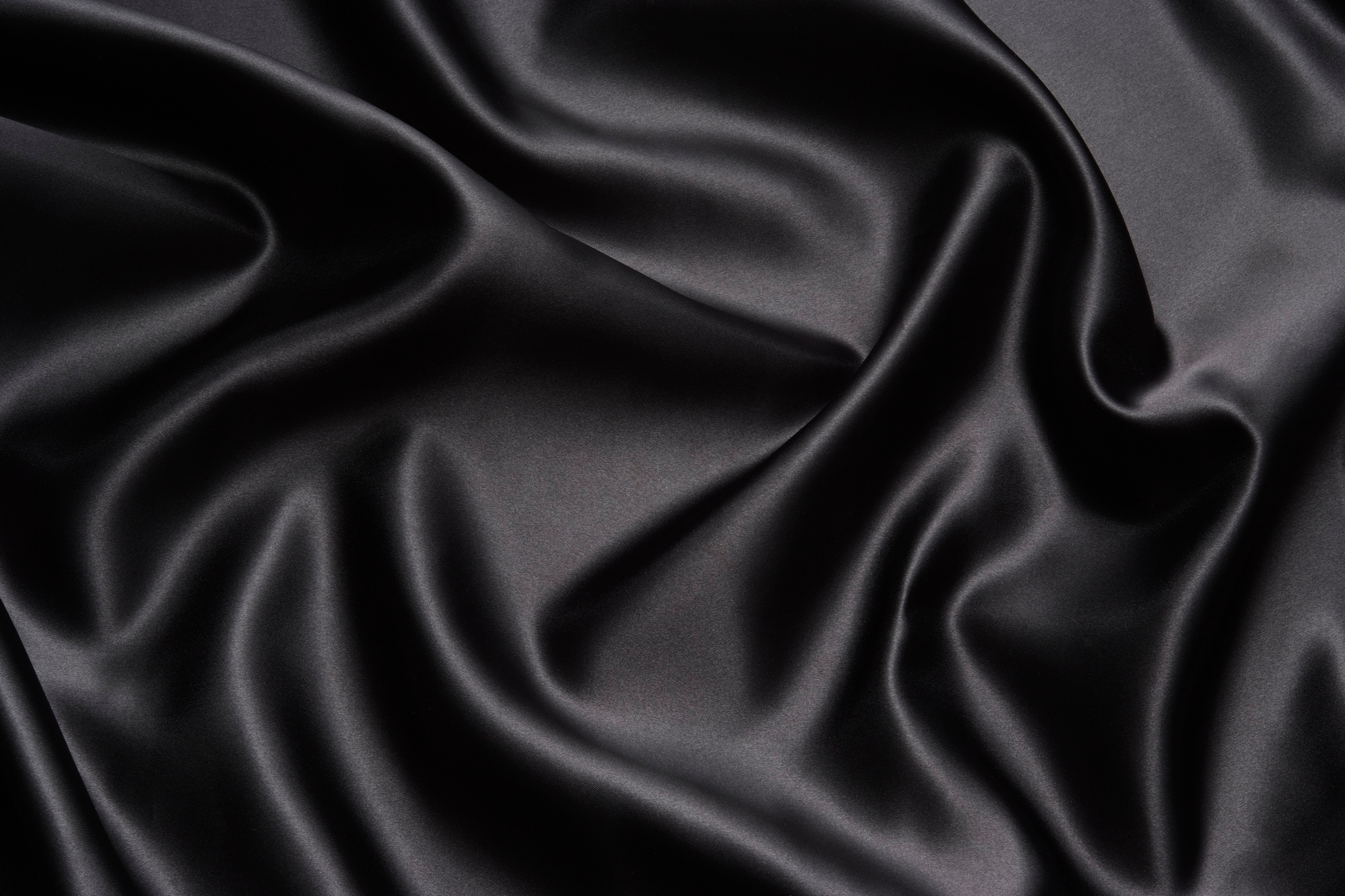 Crumpled black satin texture background